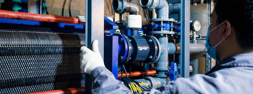 Data center specialist inspects industrial liquid cooling pipe infrastructure systems